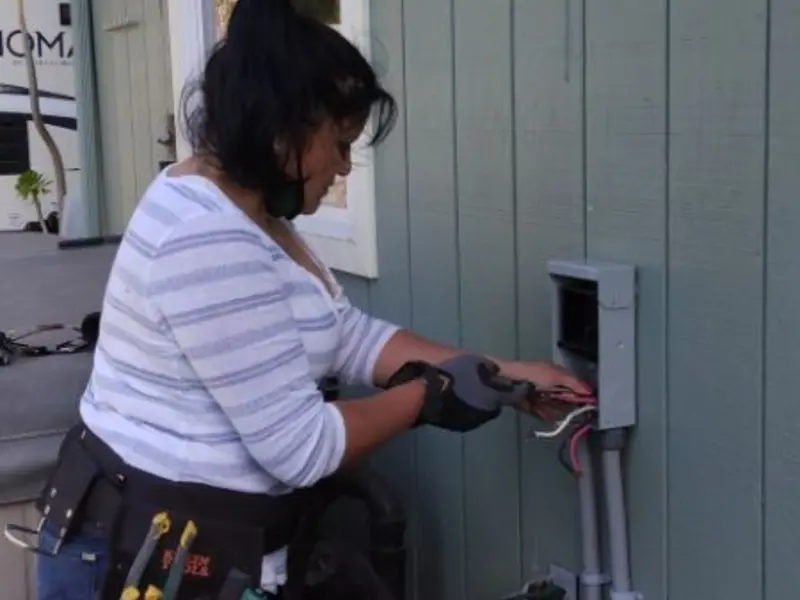 Licensed electrician wiring an exterior subpanel in Stanford